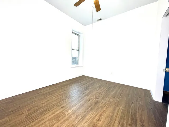 a view of a room with wooden floor