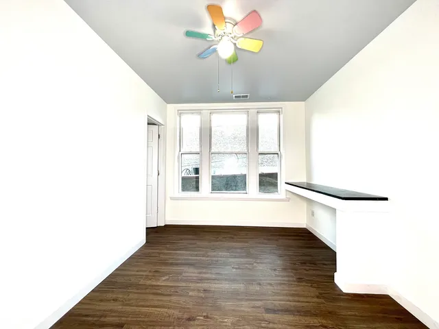a view of a room with wooden floor and window