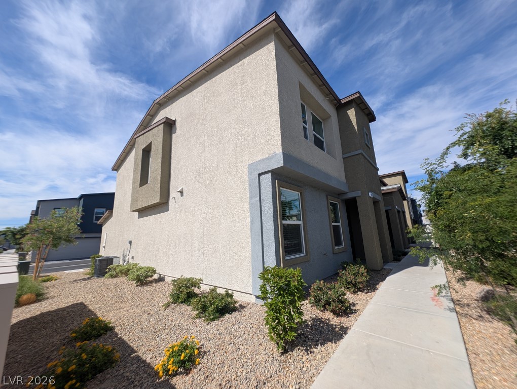 4820 Orchid Rdg Avenue Las Vegas, NV 89141 - Photo 2 of 16 Modern desert architecture with a clean stucco finish under an open sky.