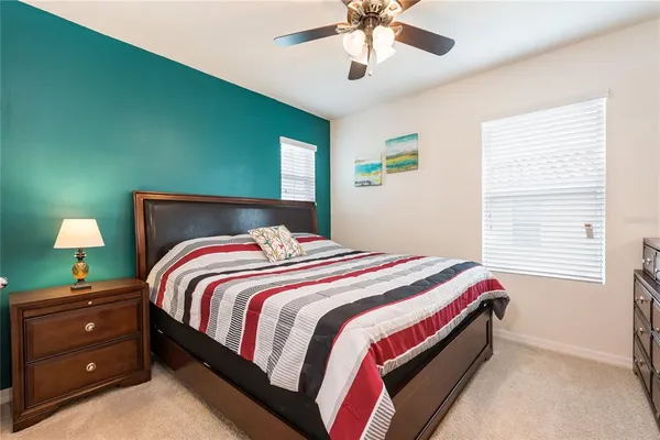 a bedroom with a bed and a mirror