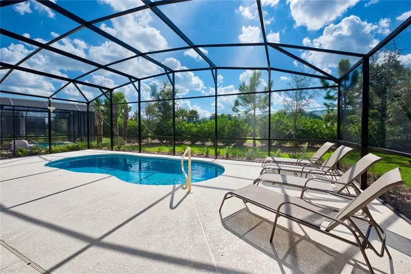 a view of swimming pool with a patio