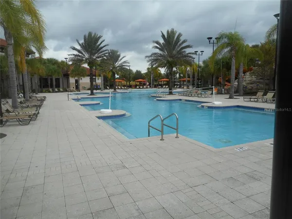 a view of a swimming pool with a yard
