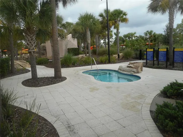 a swimming pool with outdoor seating and garden
