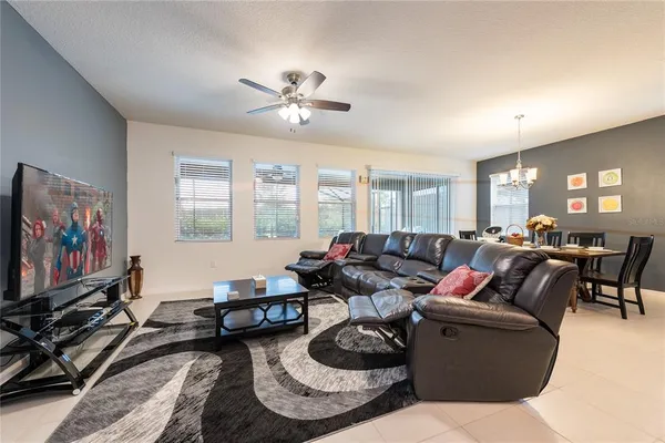 a living room with furniture a window and a flat screen tv