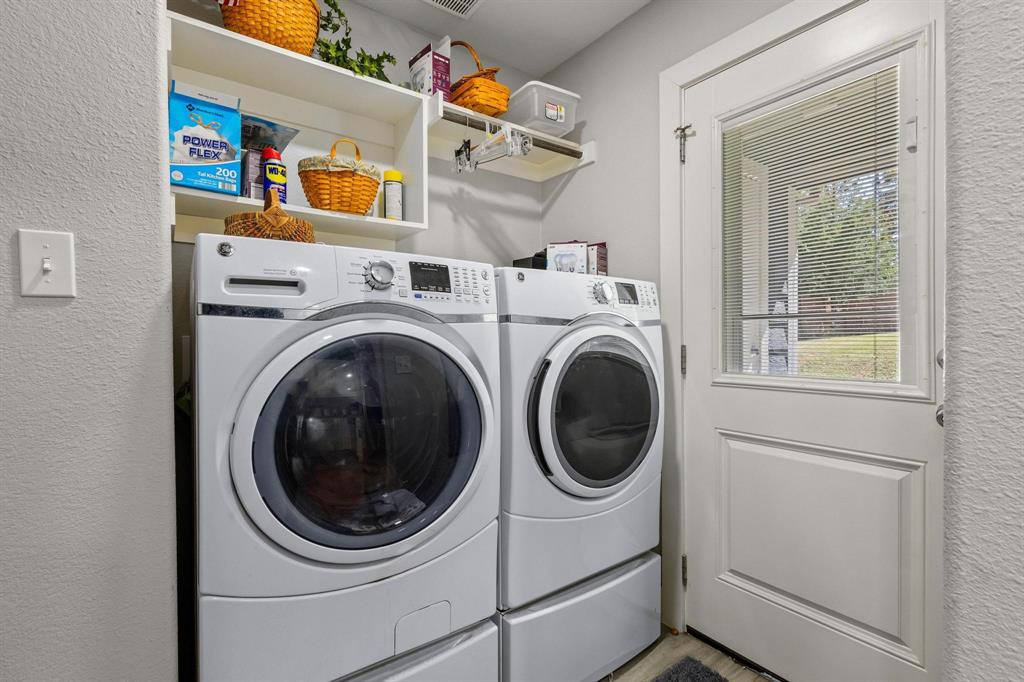 608 East Shepherd Street Denison, TX 75021 - Photo 16 of 31 Laundry area featuring white appliances, integrated storage shelves, and a paneled exterior door with an inset window and blinds
