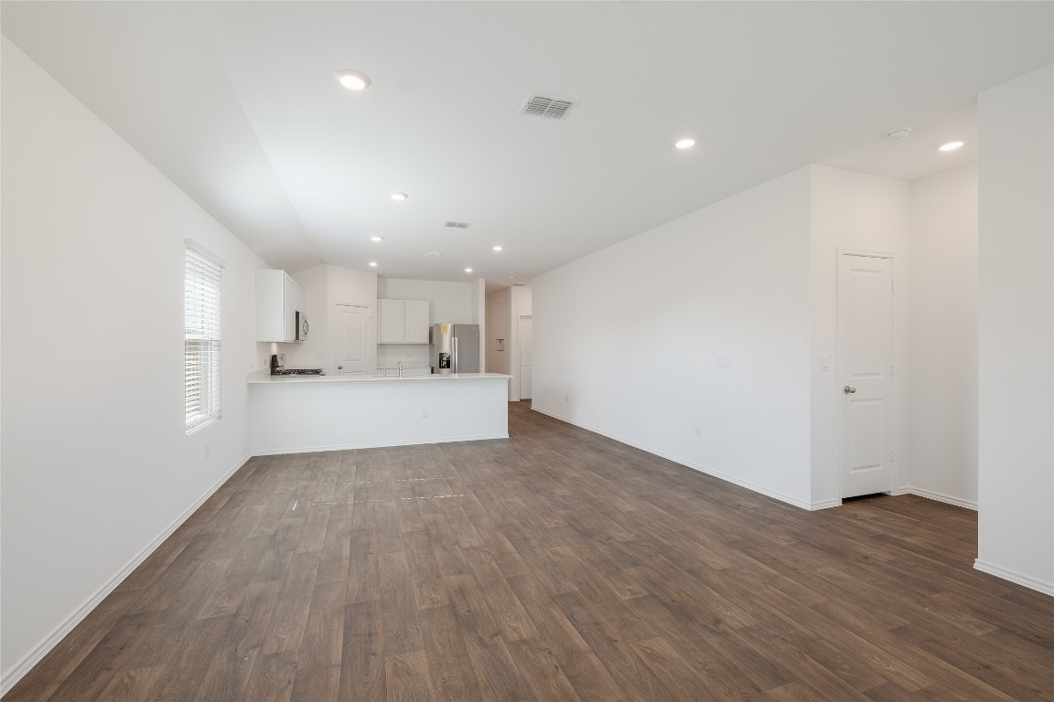 12202 Pike Bend Mustang Ridge, TX 78610 - Photo 13 of 24 a view of a kitchen with a sink and wooden floor