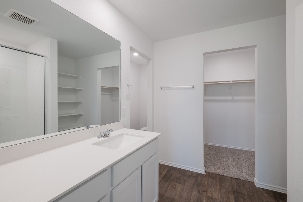 12202 Pike Bend Mustang Ridge, TX 78610 - Photo 17 of 24 a bathroom with a sink and a mirror