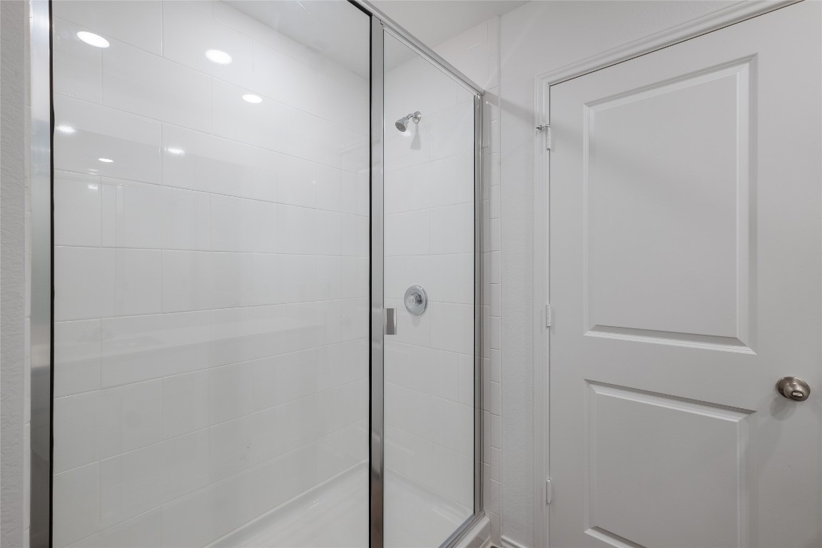 12202 Pike Bend Mustang Ridge, TX 78610 - Photo 18 of 24 a bathroom with a shower and a glass door