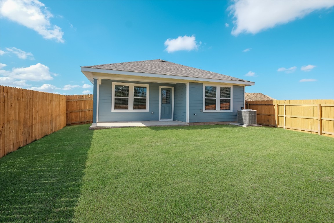 12202 Pike Bend Mustang Ridge, TX 78610 - Photo 23 of 24 a view of a house with backyard garden and tree