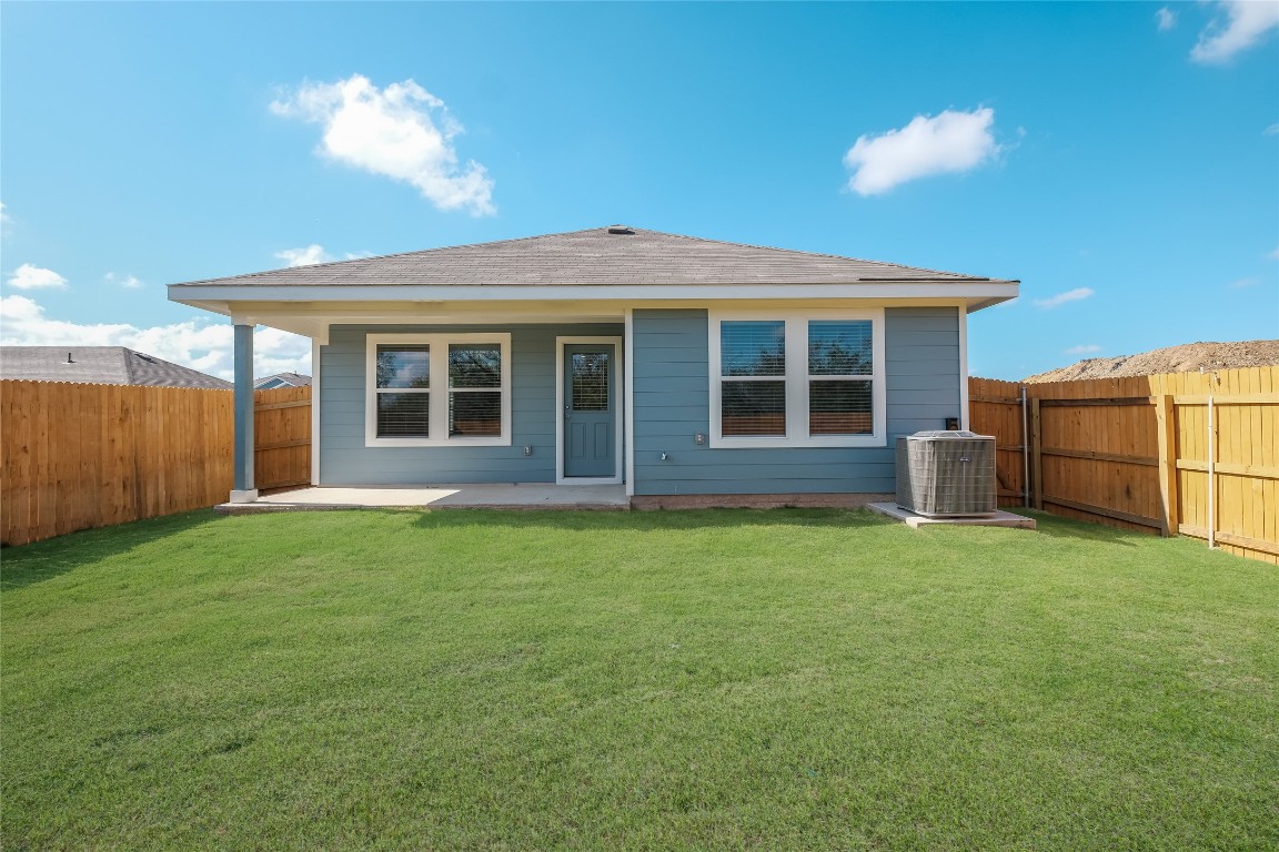 12202 Pike Bend Mustang Ridge, TX 78610 - Photo 24 of 24 a view of a house with backyard porch and garden