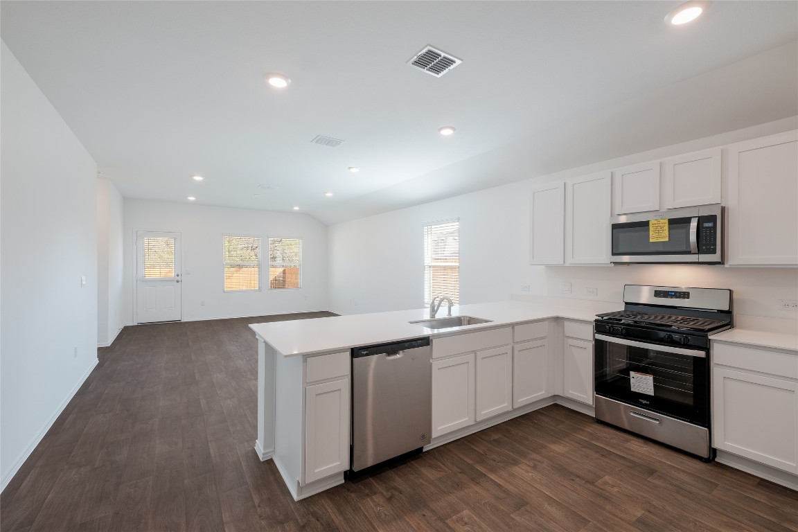 12202 Pike Bend Mustang Ridge, TX 78610 - Photo 6 of 24 a kitchen with stainless steel appliances granite countertop a sink and stove top oven