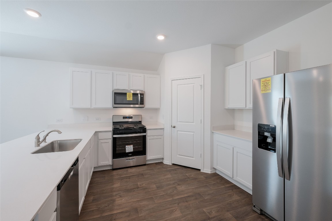 12202 Pike Bend Mustang Ridge, TX 78610 - Photo 7 of 24 a kitchen with a refrigerator stove and sink