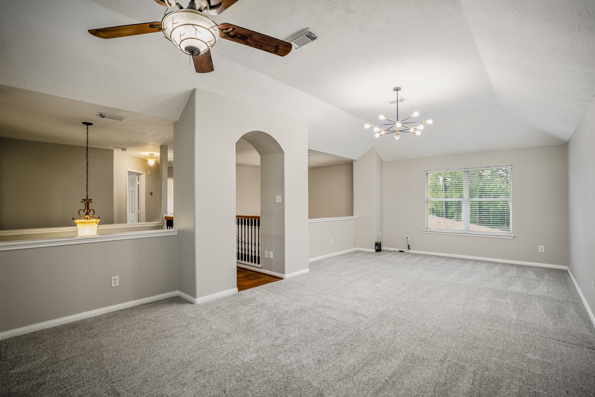 6311 Sparrows Glen Lane Spring, TX 77379 - Photo 25 of 50 From the opposite side of the gameroom, you can see the size and flexibility of the upstairs living area, with updated lighting overhead, soft carpet underfoot, and the open railing keeping the space connected to the rest of the home.