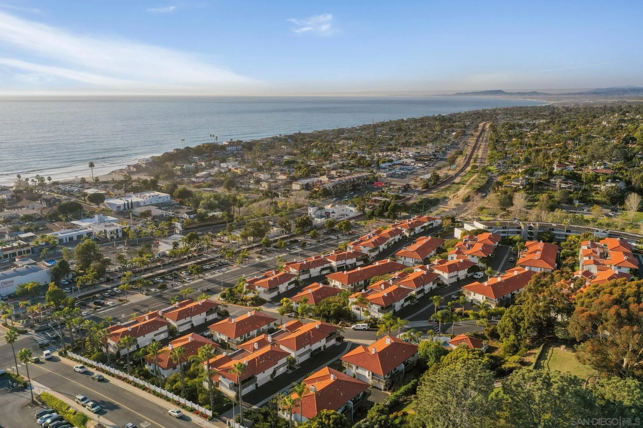 an aerial view of residential building and ocean