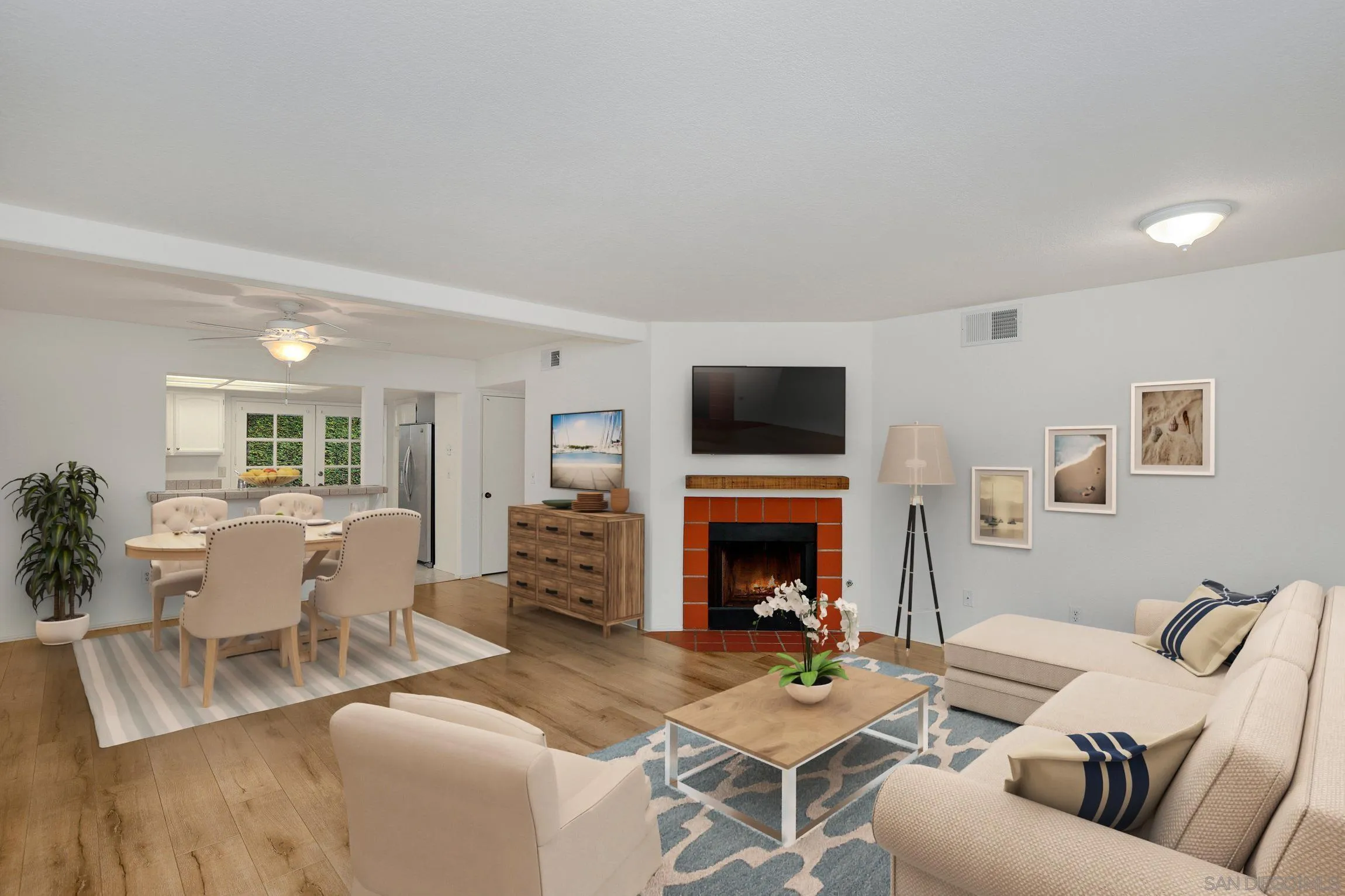 381 Playa Blanca Encinitas, CA 92024 - Photo 7 of 41 a living room with furniture flat screen tv and a fireplace