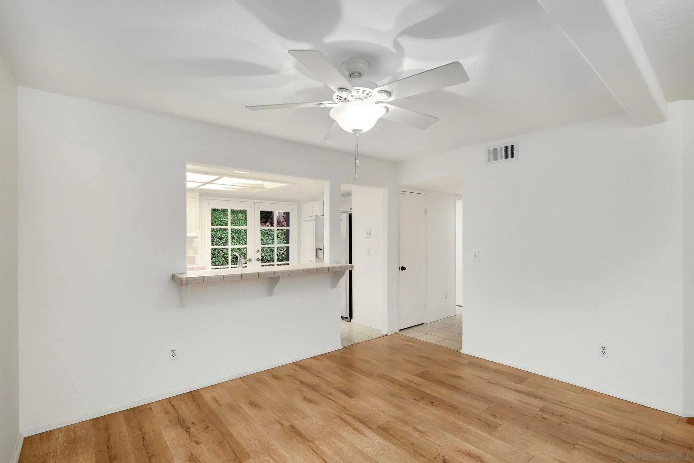 381 Playa Blanca Encinitas, CA 92024 - Photo 9 of 41 a view of empty room with wooden floor and fan