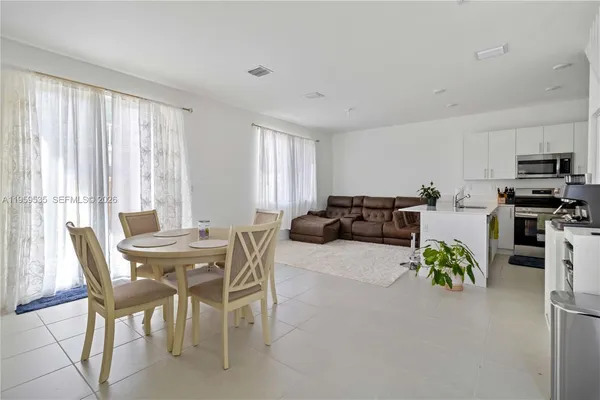 a view of kitchen with furniture and a potted plant