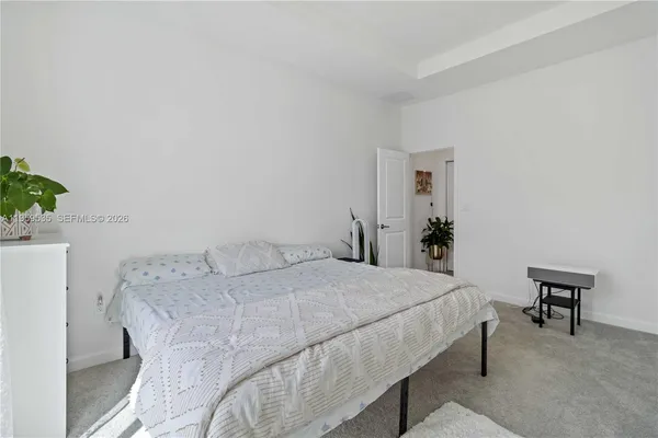 a bedroom with a bed and a table in it