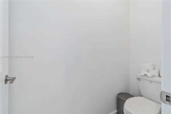 a white toilet sitting next to a white sink