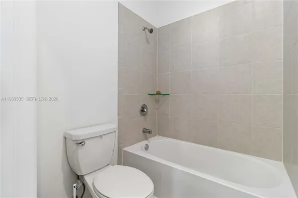 a white bath tub sitting next to a toilet