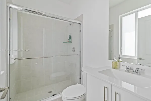 a bathroom with a sink toilet and shower