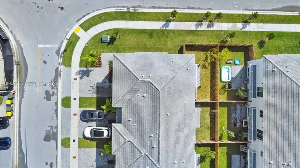 an aerial view of houses with a swimming pool