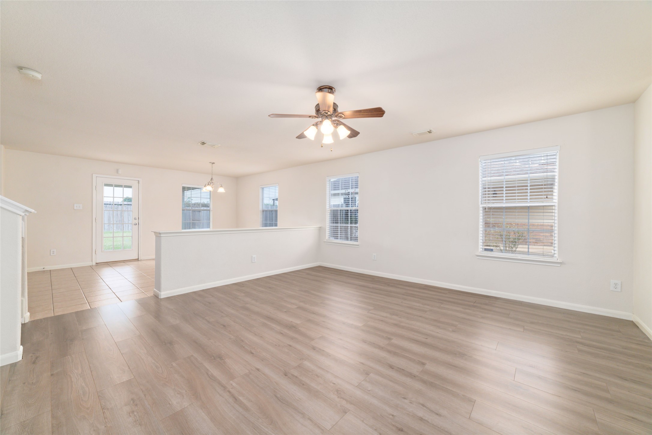 21311 Shadow River Lane Spring, TX 77379 - Photo 16 of 38 wooden floor in an empty room with a window
