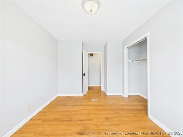a view of a room with wooden floor