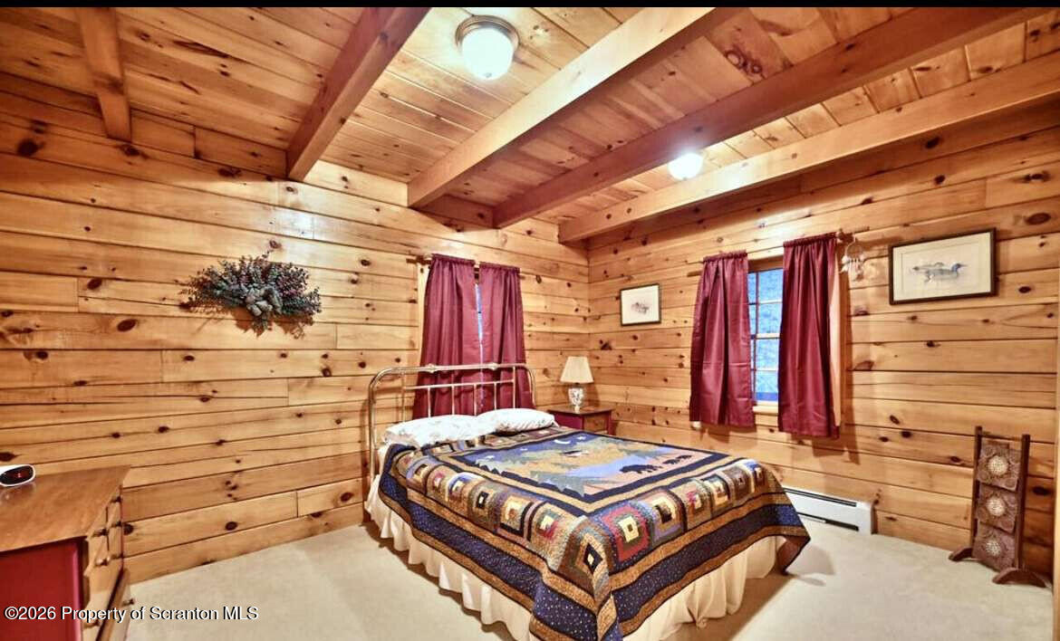 9 East Lake Road Moscow, PA 18444 - Photo 20 of 48 a bed sitting in a bedroom next to a window