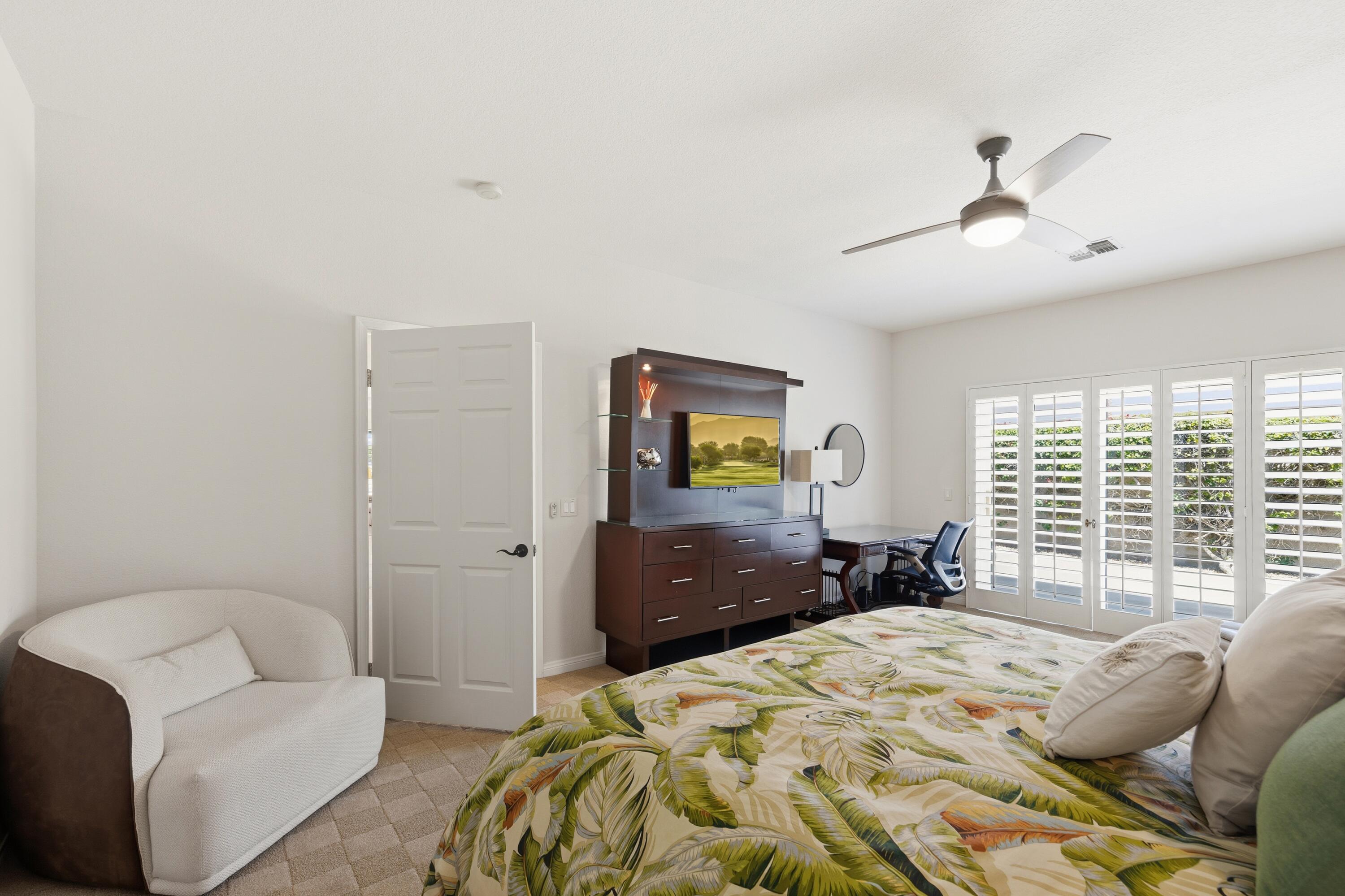 39 Augusta Drive Rancho Mirage, CA 92270 - Photo 26 of 53 a bedroom with a bed and a couch