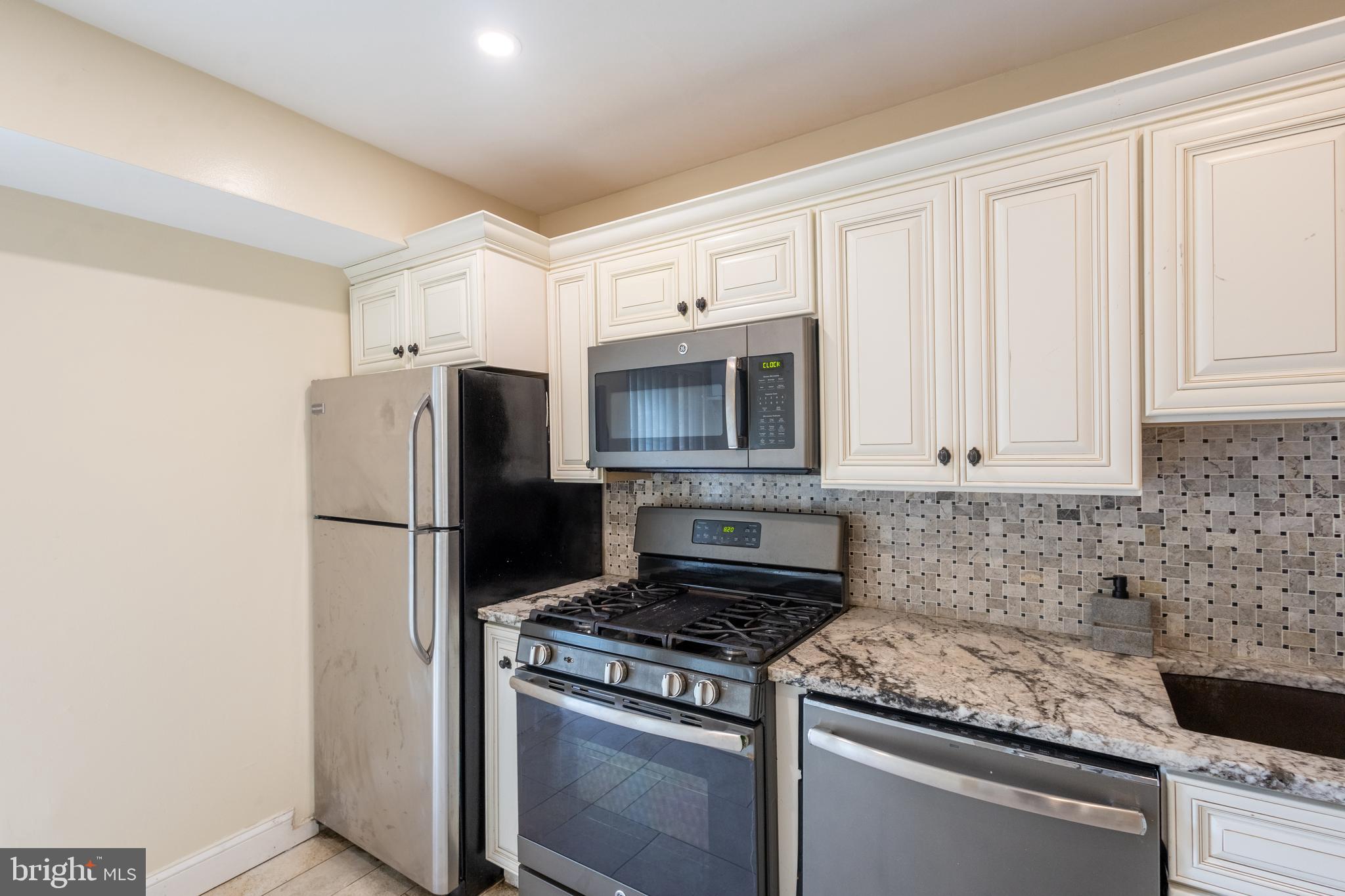 3332 Claridge Court Silver Spring, MD 20902 - Photo 19 of 30 a kitchen with a stove microwave and refrigerator