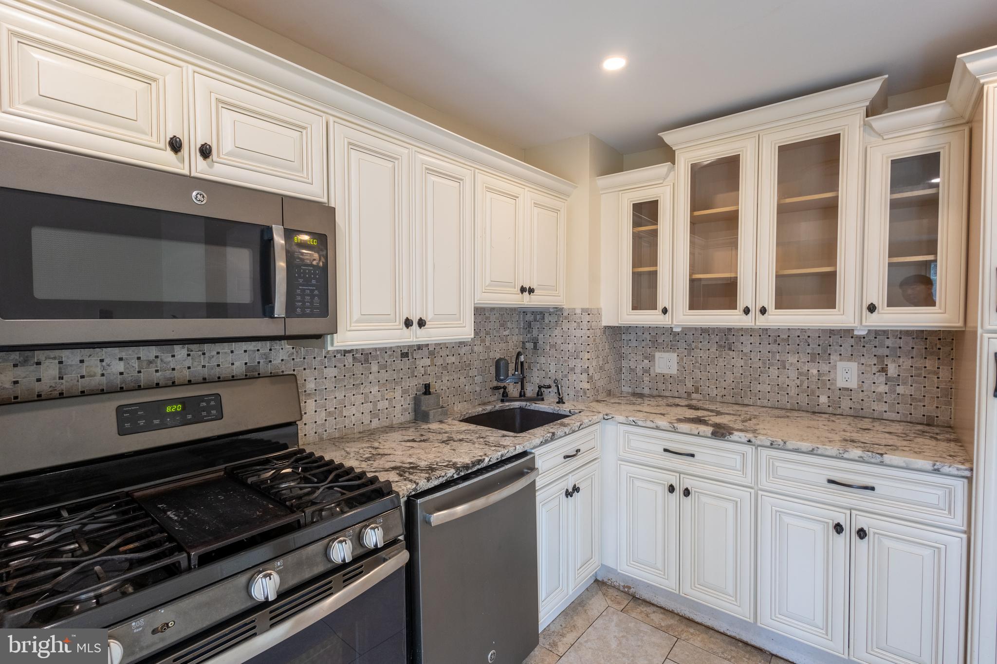 3332 Claridge Court Silver Spring, MD 20902 - Photo 22 of 30 a kitchen with granite countertop a stove and a sink