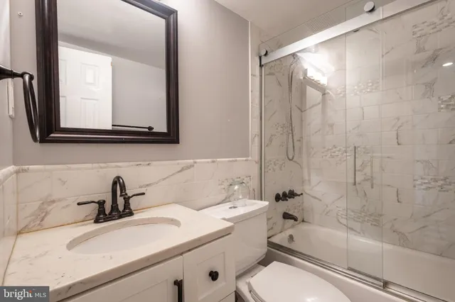 a bathroom with a sink a toilet and a bathtub