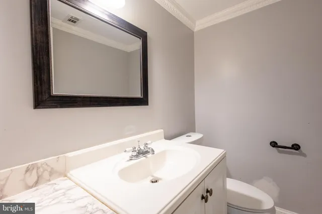 a bathroom with a sink vanity and mirror