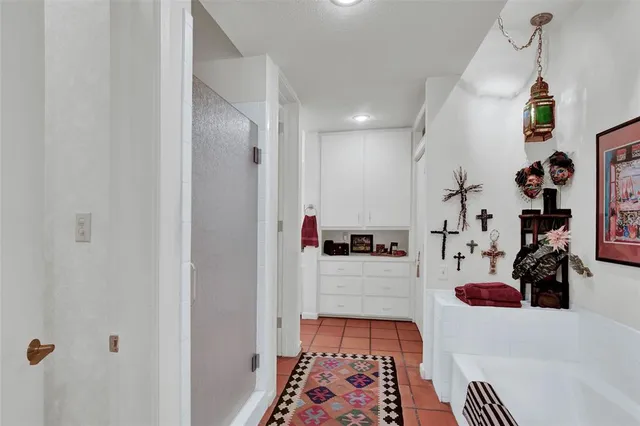 a view of a hallway with workspace and living room