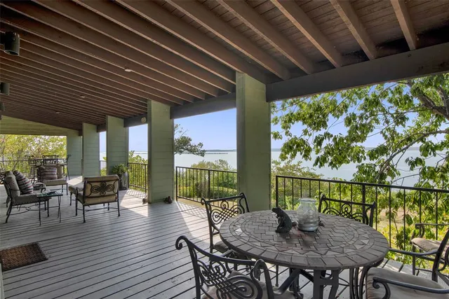 a view of balcony with chairs and wooden floor
