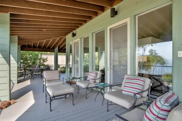 a balcony with furniture and wooden floor