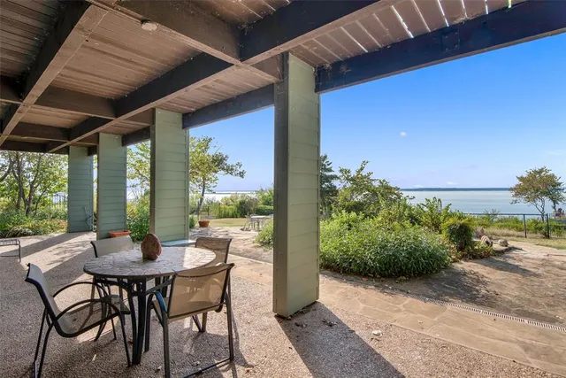a view of an outdoor dining space with a table and chairs