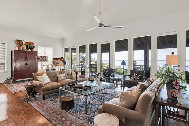 a living room with furniture large window and outer view