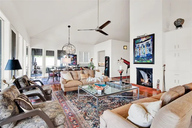 a living room with furniture a fireplace and a chandelier
