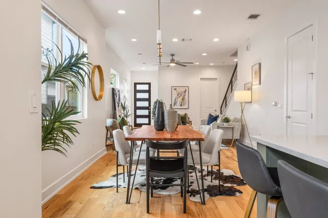 a kitchen with kitchen island a large counter top space a sink stainless steel appliances and windows
