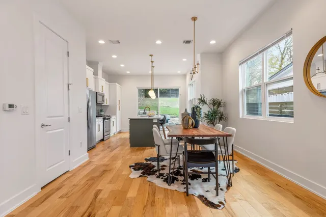 a dining room with furniture and wooden floor