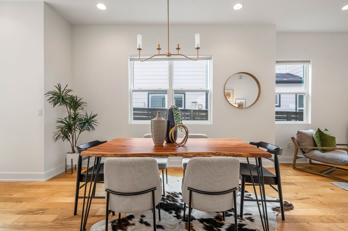 1301 Cometa Street, Unit A Austin, TX 78721 - Photo 13 of 38 Statement chandelier, and neutral finishes that complement the home’s modern aesthetic