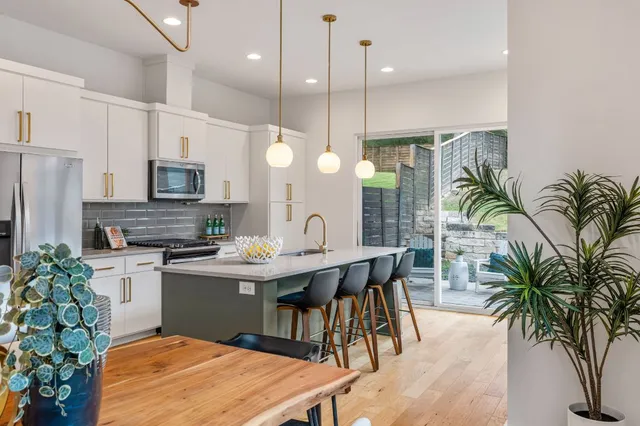 a kitchen with sink and refrigerator