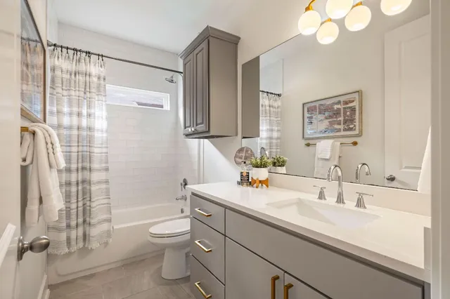 a bathroom with a double vanity sink and a mirror