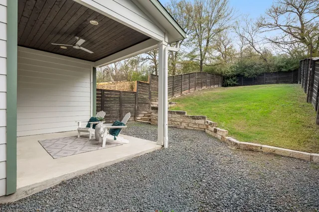 a view of a porch with chairs and backyard