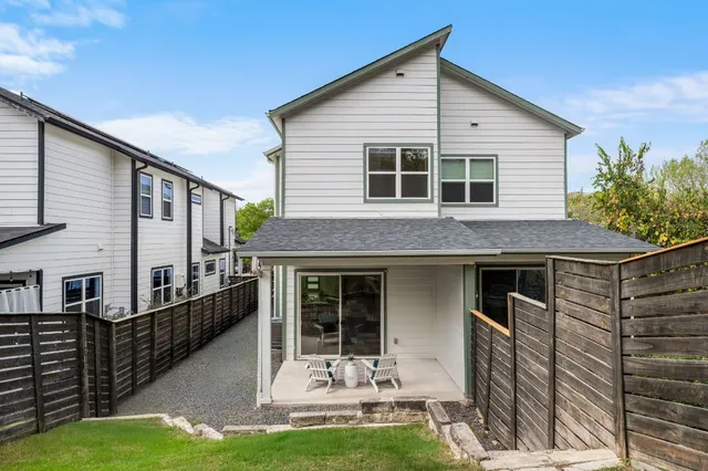 a view of a house with backyard and porch
