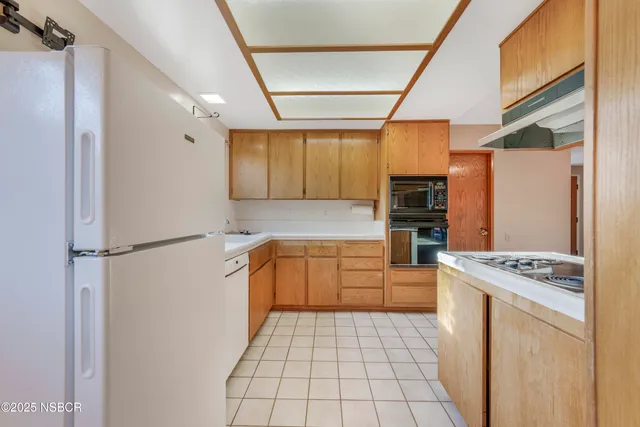 a kitchen with stainless steel appliances a refrigerator stove and sink