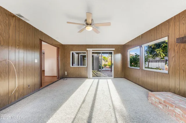 a view of a livingroom with a ceiling fan and window