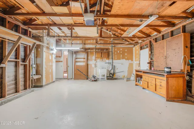 an aerial view of a house with outdoor space and a lake view